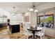Eat-in kitchen features a center island, stainless steel appliances, stone tile flooring, and a large window view at 24200 N Alma School Rd # 7, Scottsdale, AZ 85255