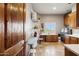 Large laundry room with tile flooring, white countertops, modern appliances, and custom cabinets at 24200 N Alma School Rd # 7, Scottsdale, AZ 85255