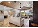 Open-concept living room with a fireplace, wood plank ceiling, large windows, and tile flooring at 24200 N Alma School Rd # 7, Scottsdale, AZ 85255