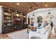 Spacious living room featuring a built-in entertainment center, white sofas, a fireplace, and tile flooring at 24200 N Alma School Rd # 7, Scottsdale, AZ 85255
