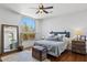 Bright bedroom featuring hardwood floors, a large window with a view, and neutral decor at 24200 N Alma School Rd # 7, Scottsdale, AZ 85255