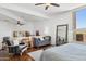 Bright main bedroom with wood floors, a seating area, and a view of the outside at 24200 N Alma School Rd # 7, Scottsdale, AZ 85255