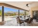Covered patio area with mountain views, dining table, ceiling fans, and access to the pool at 24200 N Alma School Rd # 7, Scottsdale, AZ 85255