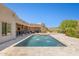 Backyard pool featuring travertine deck, water features, desert landscaping, and a covered patio at 24200 N Alma School Rd # 7, Scottsdale, AZ 85255