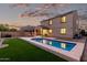 Spacious backyard with a pool and covered patio, offering a serene setting against a beautiful evening sky at 2993 E Meadowview Dr, Gilbert, AZ 85298