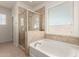 Large tub and walk-in shower in bathroom with decorative tile at 2993 E Meadowview Dr, Gilbert, AZ 85298
