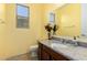 Cozy bathroom featuring a granite countertop vanity, decorative floral arrangement, and neutral tile flooring at 2993 E Meadowview Dr, Gilbert, AZ 85298