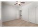 A bedroom with carpet, neutral colored walls, ceiling fan, two doors and baseboard trim at 2993 E Meadowview Dr, Gilbert, AZ 85298
