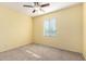 Bedroom with a ceiling fan, a window, and neutral walls and carpet at 2993 E Meadowview Dr, Gilbert, AZ 85298
