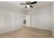 Bedroom with carpet, neutral colored walls, ceiling fan, two doors and baseboard trim at 2993 E Meadowview Dr, Gilbert, AZ 85298