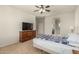 Bedroom featuring soft carpet, ceiling fan and attached bathroom at 2993 E Meadowview Dr, Gilbert, AZ 85298