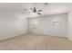 Bright bedroom featuring neutral carpeting, a ceiling fan, and multiple windows at 2993 E Meadowview Dr, Gilbert, AZ 85298