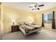 Tranquil bedroom with ceiling fan and bright light from the large window at 2993 E Meadowview Dr, Gilbert, AZ 85298