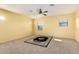 Spacious bedroom illuminated by natural light, complemented by an ornate area rug and ceiling fan at 2993 E Meadowview Dr, Gilbert, AZ 85298