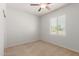 A bedroom with a ceiling fan, a window with blinds and neutral colored walls at 2993 E Meadowview Dr, Gilbert, AZ 85298