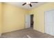 Empty bedroom featuring a ceiling fan, neutral walls, and a closet at 2993 E Meadowview Dr, Gilbert, AZ 85298