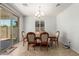Formal dining room with a wooden table set, chandelier, and tile flooring at 2993 E Meadowview Dr, Gilbert, AZ 85298