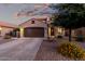 Charming single-Gathering home with a brown two car garage and colorful desert landscaping at 2993 E Meadowview Dr, Gilbert, AZ 85298