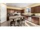 Modern kitchen with stainless steel appliances, a kitchen island and plenty of dark cabinets at 2993 E Meadowview Dr, Gilbert, AZ 85298