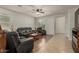 Inviting living room with plush leather seating, modern ceiling fan, and stylish decor at 2993 E Meadowview Dr, Gilbert, AZ 85298