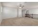 Bright living room with neutral carpeting and wood railing at 2993 E Meadowview Dr, Gilbert, AZ 85298