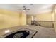 Bright and airy loft space with neutral carpeting, a ceiling fan, and a decorative area rug at 2993 E Meadowview Dr, Gilbert, AZ 85298