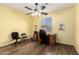 Office space featuring a ceiling fan, wood floors, and a desk with chairs at 2993 E Meadowview Dr, Gilbert, AZ 85298