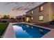 Backyard pool featuring the home's exterior and covered patio, set against a vibrant sunset backdrop at 2993 E Meadowview Dr, Gilbert, AZ 85298