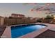 Inviting backyard pool providing a refreshing oasis with privacy fencing, complemented by the evening sky at 2993 E Meadowview Dr, Gilbert, AZ 85298