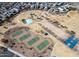 Aerial view showcasing the community park with playground, tennis courts, and basketball court at 30165 W Flower St, Buckeye, AZ 85396