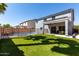 Home boasts a large backyard, turf, fencing, a pool, and a covered patio at 30165 W Flower St, Buckeye, AZ 85396