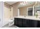 Bathroom featuring a single sink vanity with dark cabinets and shower with bathtub combo at 30165 W Flower St, Buckeye, AZ 85396