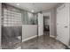 Bathroom with a tiled shower enclosure with glass blocks and a view into the bedroom at 30165 W Flower St, Buckeye, AZ 85396
