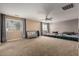 Spacious bedroom features neutral tones, carpeted flooring, ceiling fan, and natural light at 30165 W Flower St, Buckeye, AZ 85396