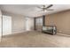 Bright bedroom featuring a ceiling fan, neutral tones, carpeted flooring, and natural light at 30165 W Flower St, Buckeye, AZ 85396