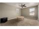 Bedroom featuring neutral walls, carpet floors, ceiling fan, and natural light from the windows at 30165 W Flower St, Buckeye, AZ 85396
