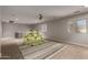 Spacious bonus room featuring carpet floors, a ceiling fan, and natural light from the windows at 30165 W Flower St, Buckeye, AZ 85396