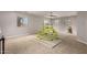Spacious bonus room featuring neutral walls, carpet floors, and natural light from the windows at 30165 W Flower St, Buckeye, AZ 85396
