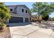 Two-story home with a three-car garage and landscaped front yard at 30165 W Flower St, Buckeye, AZ 85396