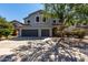 Two-story home with a three-car garage and landscaped front yard at 30165 W Flower St, Buckeye, AZ 85396