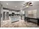 A kitchen features white cabinets, a granite countertop island, and stainless steel appliances at 30165 W Flower St, Buckeye, AZ 85396