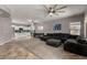 Open living space with a sectional sofa, kitchen and sliding glass doors at 30165 W Flower St, Buckeye, AZ 85396