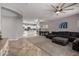 Open living space with a sectional sofa, kitchen and sliding glass doors at 30165 W Flower St, Buckeye, AZ 85396