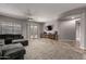 Open living space with a large sectional sofa and a television on the wall at 30165 W Flower St, Buckeye, AZ 85396