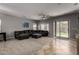 Open living space with a large sectional sofa and sliding glass doors at 30165 W Flower St, Buckeye, AZ 85396