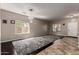 Open-concept living room with a rug, windows, and a door at 30165 W Flower St, Buckeye, AZ 85396