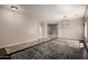 Spacious living room with tile floors and decorative light fixture at 30165 W Flower St, Buckeye, AZ 85396