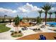 Community playground featuring covered picnic areas and splash pad surrounded by palm trees at 30165 W Flower St, Buckeye, AZ 85396