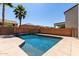 Private backyard pool surrounded by lush landscaping and a large patio area at 30165 W Flower St, Buckeye, AZ 85396