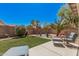 Well-maintained backyard featuring manicured lawn, desert landscaping, and decorative accents at 30259 N Sunray Dr, San Tan Valley, AZ 85143